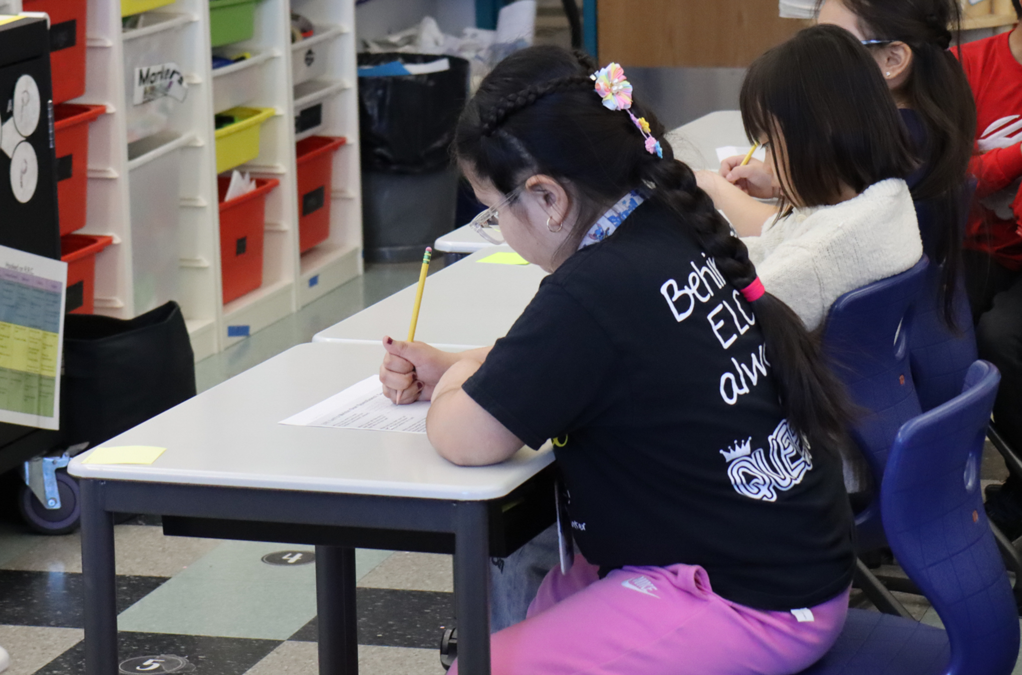 Hooks School students sitting at their desks working on an assignment. Students are writing on a worksheet.